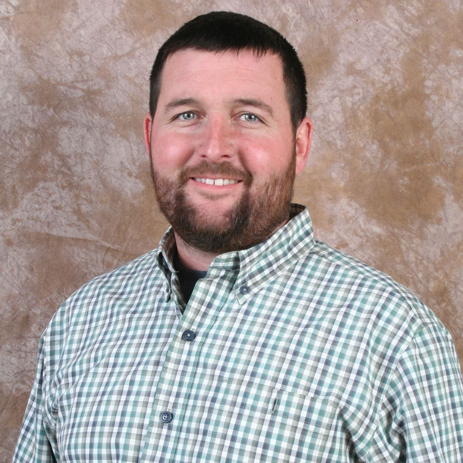 man smiling in button down shirt