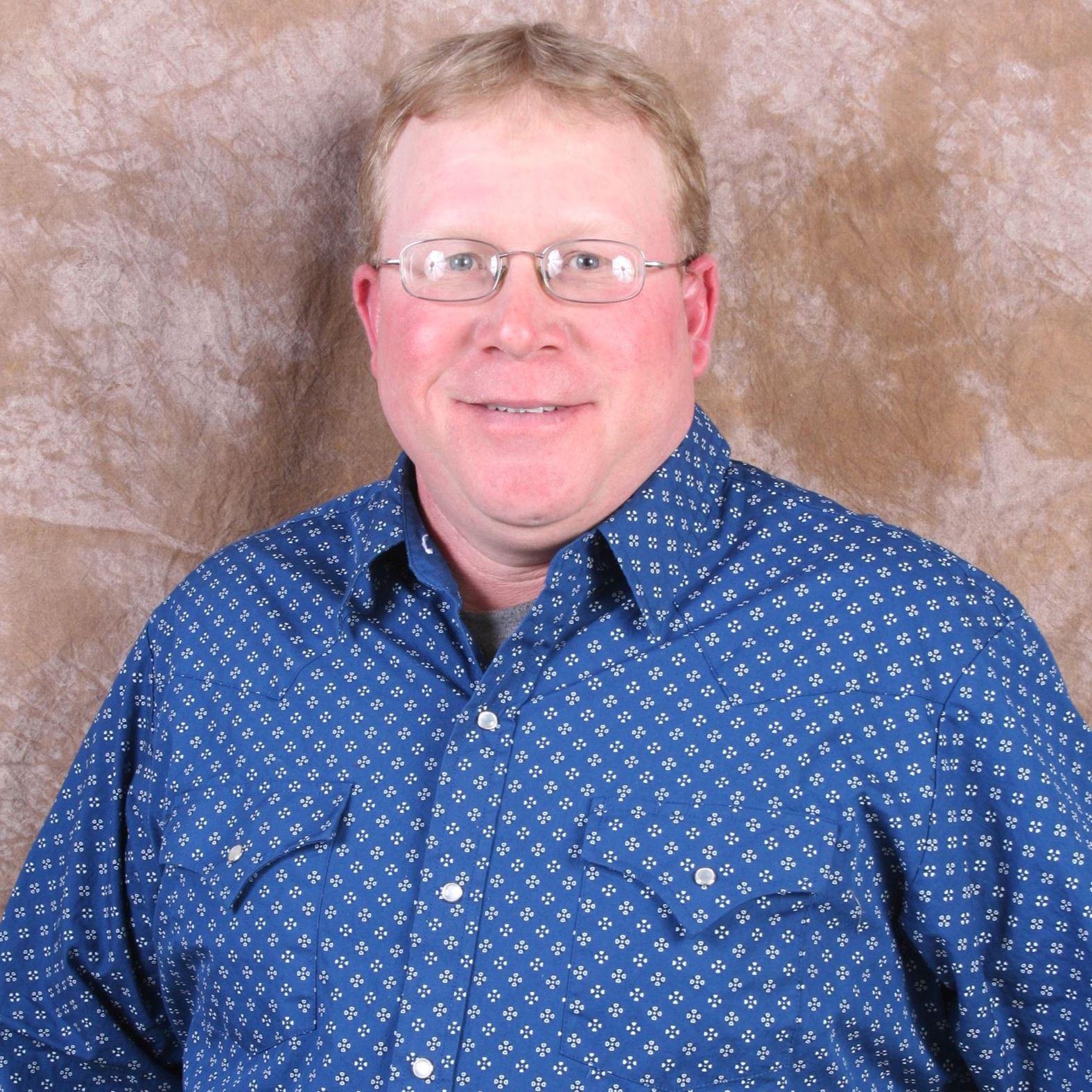 man in glasses in button down shirt